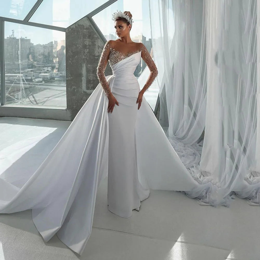 Instant Savings Elegant Mermaid Wedding Dress with Illusion Neckline, Beaded Long Sleeves, and a Detachable Overskirt Instant Savings Elegant Mermaid Wedding Dress with Illusion Neckline, Beaded Long Sleeves, and a Detachable Overskirt